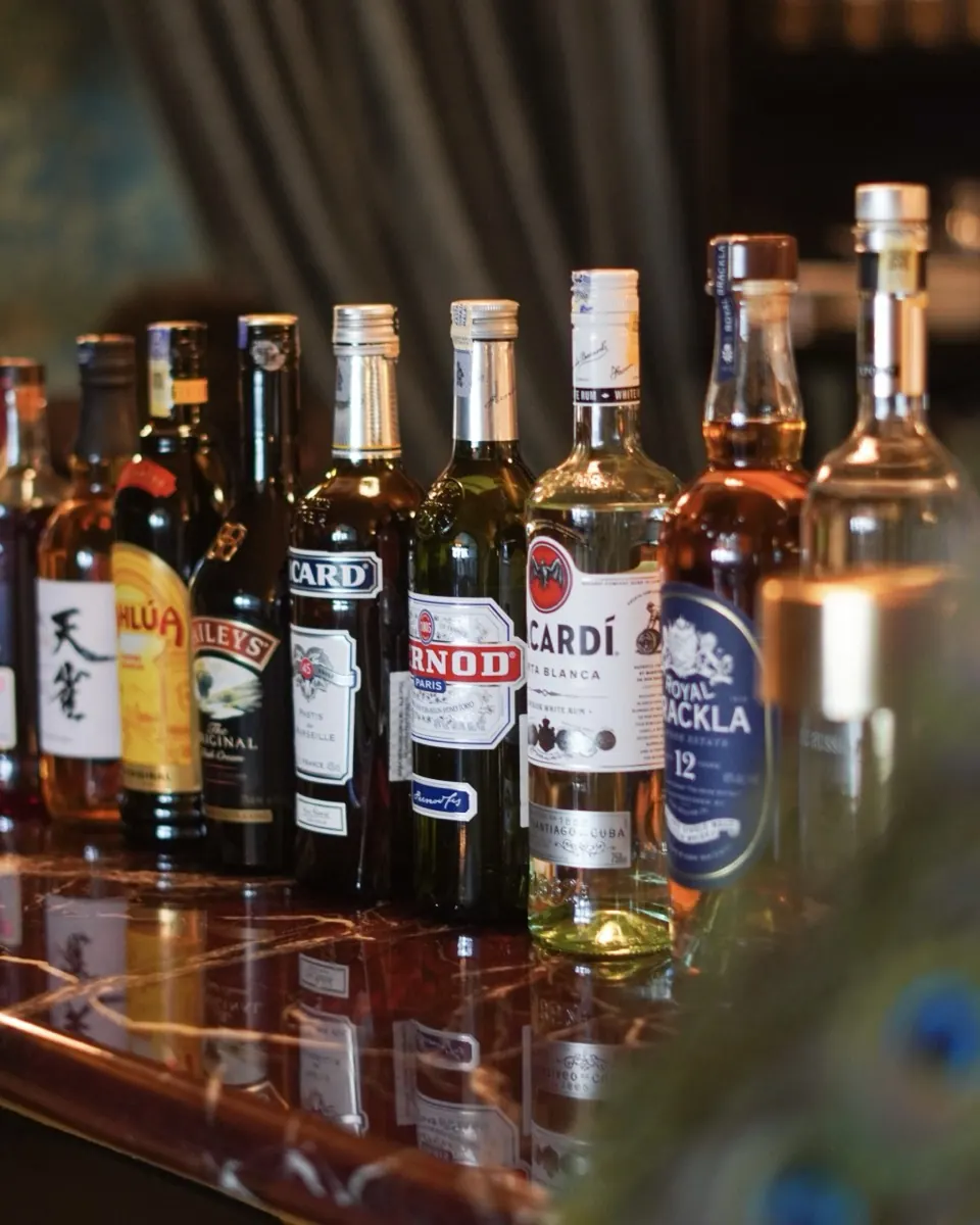 Spirits lined along the restaurant's red marble bar top